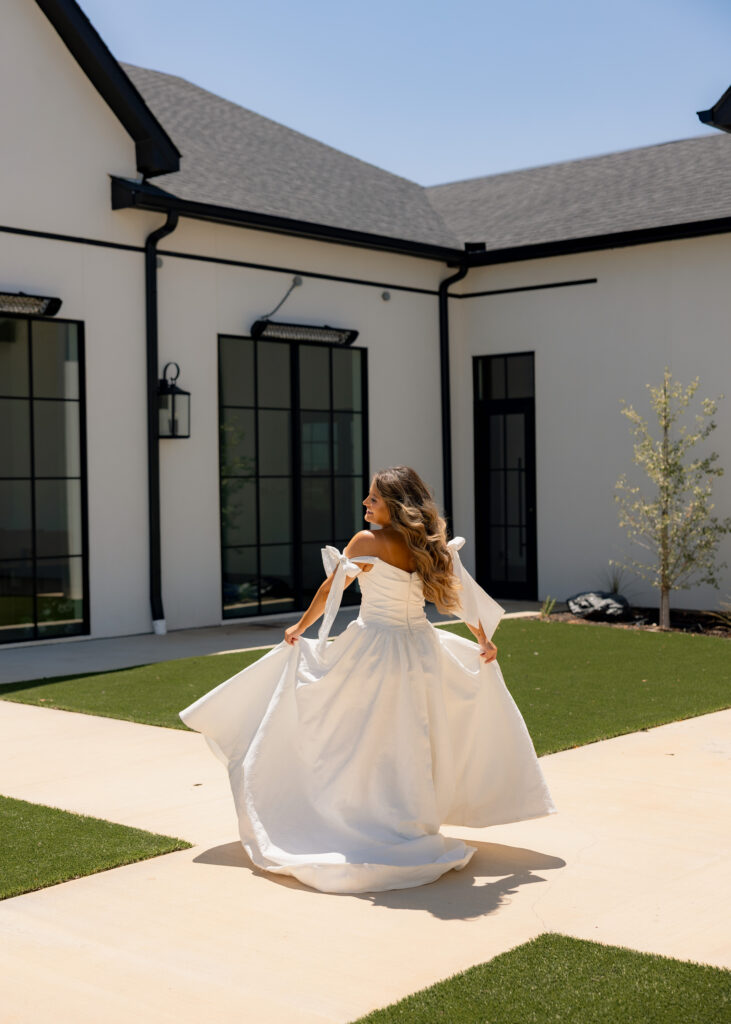 a bride is walking in front of Grace Manor Events DFW