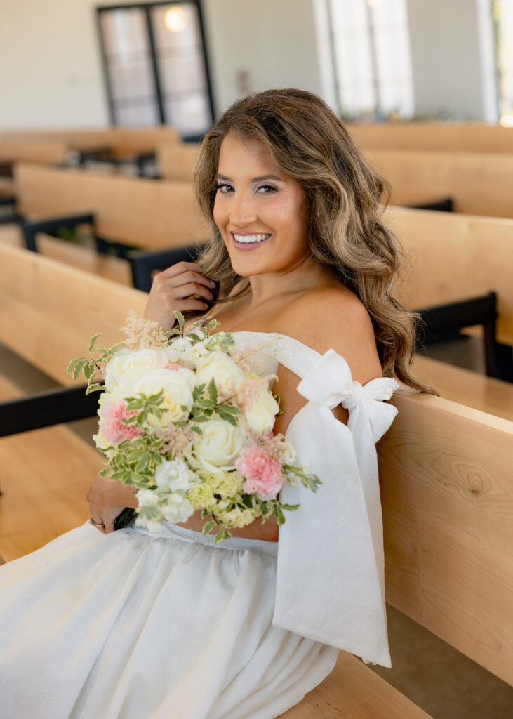 Bridal Portraits A bride is sitting in the Grace Manor Chapel